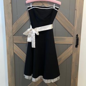 Black strapless swing dress with champagne tulle and sash